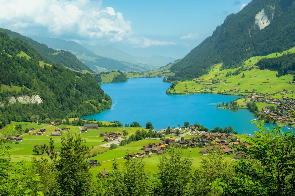 The turquoise Lake Lungern with the village of Lungern, seen from above